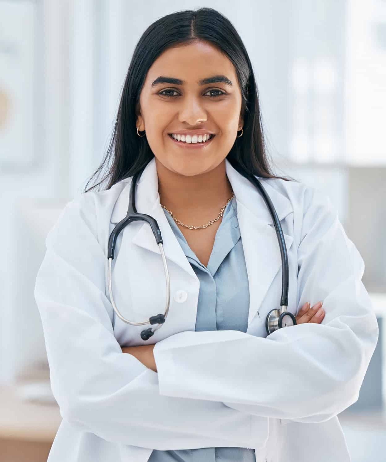 Indian woman, doctor and arms crossed in hospital with trust, wellness goals or healthcare motivati