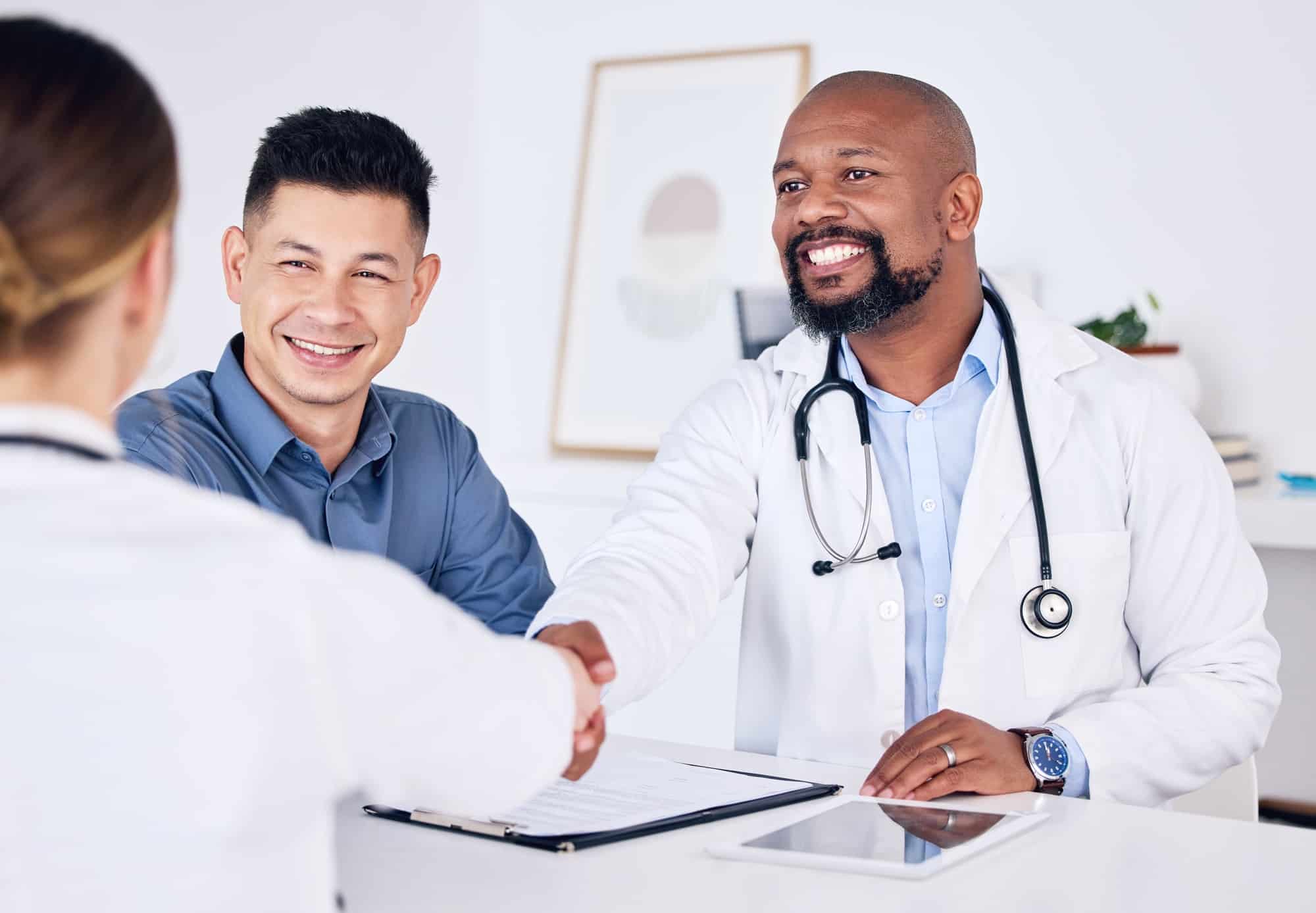 Its always great meeting new clients. Shot of two doctors shaking hands at a clinic.